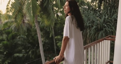 clip-3983222565-young-woman-oversized-shirt-playfully-looks-out