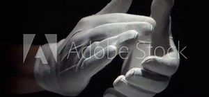 Gloved hands clapping on black background close up