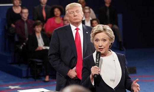 Trump 'prowls' behind Clinton during presidential debate – video