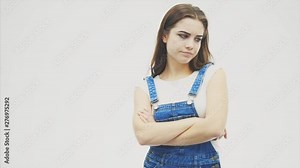 Serious angry pretty girl is shaking her head and thinking how to solve her problem.