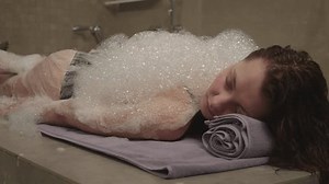 Young girl having a full body massage in spa salon. Massage with foam at the spa