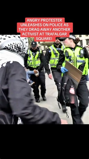 ANGRY PROTESTER UNLEASHES ON POLICE AS THEY DRAG AWAY ANOTHER ACTIVIST AT TRAFALGAR SQUARE!