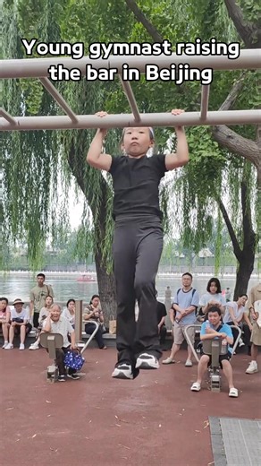 A girl shows off her strength and balance with a horizontal bar routine at Houhai scenic area in #Beijing. Her smooth swings and controlled kicks draw a crowd, with each move highlighting surprising power and discipline for her age. #TrendinginChina | Xi's Moments