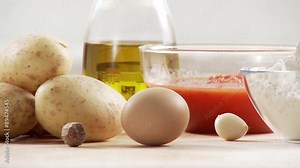 Ingredients for gnocci with tomato sauce: potatoes, egg, flour, tomato sauce, olive oil