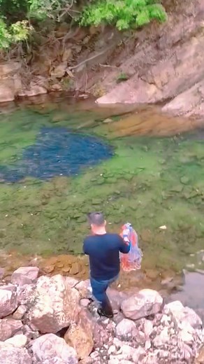Exploring Nature: Man Discovers Blue Object in River