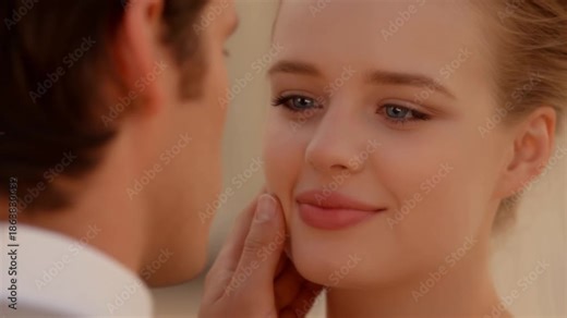 A tender moment between a couple, a man caressing a woman's face lovingly. The woman has a smile. Stock Video