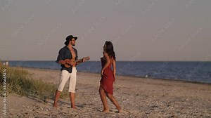Couple Dancing and Playing Ukulele on Beach