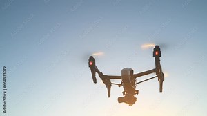 Drone, technology and sunset flight for photography surveillance or filming nature, background and blue sky. Remote control, videography and futuristic robot device or machine for aerial recording