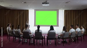 Medical Professor Teaching a Lesson to Students During a Training Course Using Green Screen, Mock-up, Chroma Key Presentation. Concept of knowledge, education, lecture, explanation, seminar