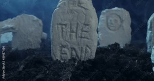 close-up of the inscription the end on the tombstone of an ancient cemetery at night.