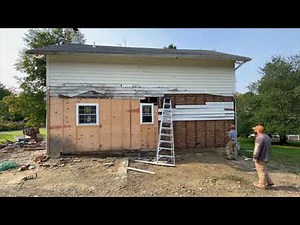 Removing old wood siding on a 1840 house with brick insulation.