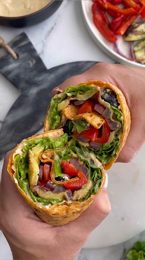 These Veggie Wraps are simple to make and perfect year round! The veggies can be prepared on an outdoor grill or even inside on a grill pan. Packed with veggies and just overall so so delicious! Ingredients ▢2 medium zucchini trimmed and sliced ▢1 bell pepper thinly sliced ▢1 small red onion cut into thin slices ▢olive oil ▢½ cup of hummus ▢¼ cup of sliced back olives ▢¼ cup of crumbled feta cheese optional ▢½ head of romaine lettuce other leafy greens work as well! ▢4 large tortilla wraps | Foo