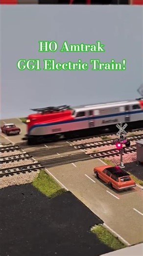 HO Amtrak GG1 Electric Passenger Train Runs Through Railroad Crossing!
