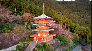beautiful Japanese pagoda in the mountains with a waterfall, aerial view of Japanese buddhist shrine, famous tourist destination in Japan
