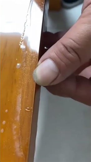 A plastic that is being cut neatly using a sharp cutting tool