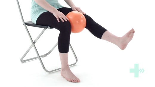 Knee extension with ball between knees - alternating Sit upright on a chair. Place a medium sized ball between your knees, and squeeze it throughout this exercise. Slowly straighten your affected knee. Control the movement as you lower the leg back down again, remembering to keep the pressure on the ball throughout. The Knee Extension with Ball Squeeze (Alternating) is a sophisticated rehabilitation exercise. It transitions from pure quad strengthening to patellar tracking control and pelvic-thi