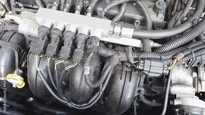 Detailed view of a car's LPG injection engine system. Close-up image showing a car's LPG injection engine system featuring detailed elements such as wiring, hoses, and engine components