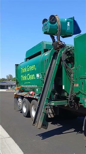 Waste Management garbage truck doing a flip trick with a recycle bin!