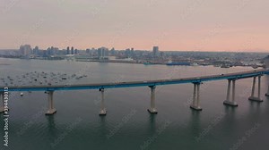 Coronado Bridge Over San Diego Bay With California Skyline In Background At Sunrise - San Diego–Coronado Bridge In California, USA. - wide pan aerial