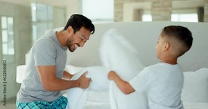 Pillow fight, play and dad with boy kid in bedroom for funny games, joke and happiness together at home. Excited child, father and laughing with pillows, crazy morning and energy to bond with family