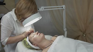 Cosmetologist using a magnifier - Free Stock Video