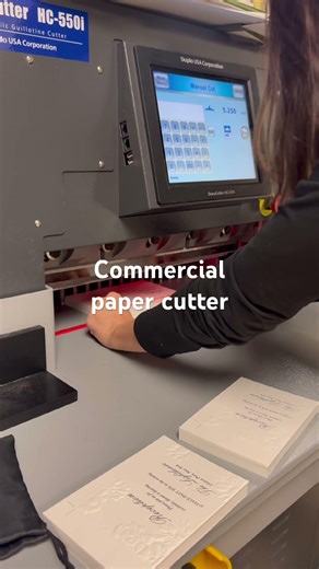 How do we cut on a commercial paper cutter?