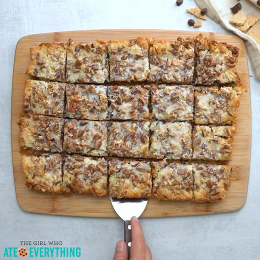 Magic Cookie Bars recipe has a buttery graham cracker crust topped with sweetened condensed milk, chocolate chips, butterscotch chips, coconut, and pecans. RECIPE: https://www.the-girl-who-ate-everything.com/magic-cookie-bars/ | The Girl Who Ate Everything