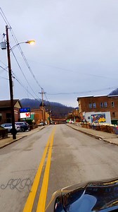 Cruising through Main Street in Jackson, Breathitt County, Kentucky at dusk with the twinkle of holiday lights to light our way home. | Angel Robinson