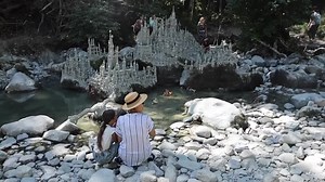 Swiss artist sculpts sprawling model castle on dried river bank