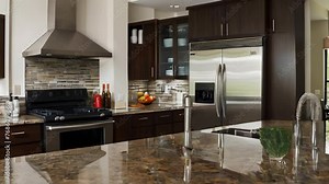 Modern kitchen design with luxury decor and stainless appliances, featuring granite countertops.