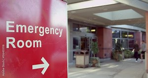 Entrance Of Modern Hospital Building With Signs