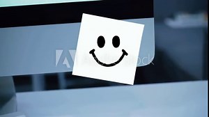 Smile character. Smile drawing on sticker on monitor. Message. Motivation. Reminder. Handwritten text written with a marker. Color sticker. A message for an employee, a colleague