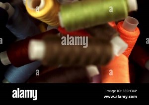 Multi-colored threads fall on the table. Filmed on a high-speed camera at 1000 fps. High quality FullHD footage