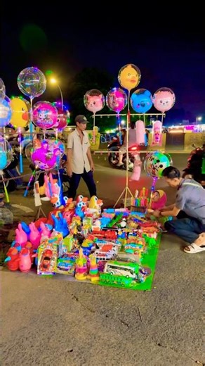 It's fun, little brother, buying Mickey Mouse balloons