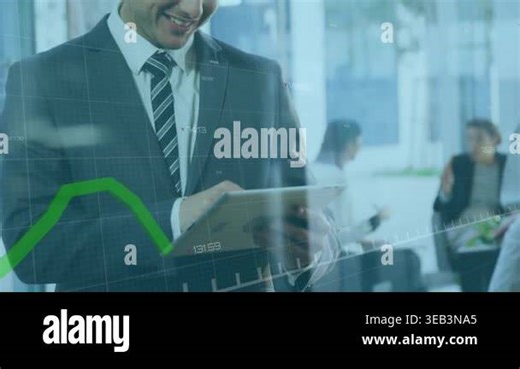A businessman smiling and using a digital tablet in an office. Global finances and statistics conceptually. The animation is of a green statistic line increasing on a digital display over a grey grid with numbers and markers Stock Video Footage - Alamy