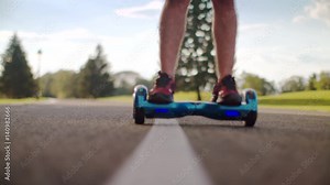 Man fall from self balance hoverboard on asphalt road. Close up of young man crash on electric gyro scooter. in city park. Accident on electric skateboard. Gyroscooter crash. Hoverboard crash