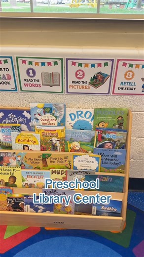 Take a tour of our preschool library center! It's a cozy corner where little learners can dive into the world of books. Our setup includes a variety of picture books, a book on CD, and comfy seating areas perfect for storytime. Discover how we organize our books to encourage independence and a love of reading in our youngest students. | Preschool Vibes