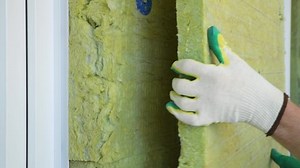 clip-1096912551-builder-insulates-external-walls-mineral-sheet-insulation