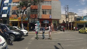 Bizarre busker dances with mannequins in the middle of the road