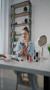 Beauty blogger talking about brow care and makeup for followers, vertical video. Influencer woman makeup artist showing daily makeup routine tutorial, trends and fashion in beauty industry, portrait