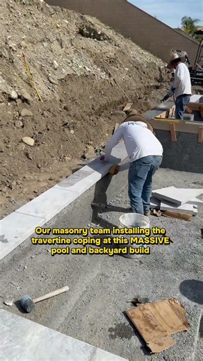 Masonry team installing coping on this new pool build
