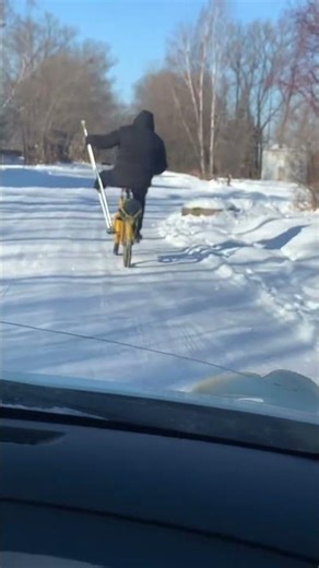 One-legged man rides bicycle using crutches in Nikolayevka, Russia