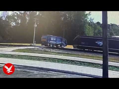 Moment Amtrak train smashes into garbage truck at crossing