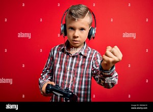 Young little caucasian gamer kid playing video games using gamepad joystick over red background annoyed and frustrated shouting with anger, crazy and Stock Photo - Alamy