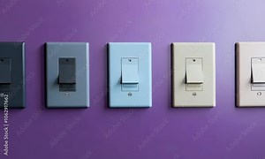 Modern light switches on a wall in various colors and designs