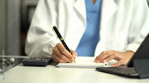 Doctor physician with stethoscope calculate medical fee costs & revenue. practitioner use calculator at Clinic.