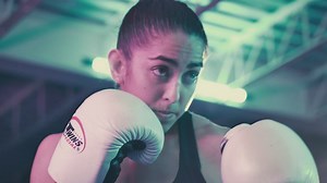 Female boxer punching a boxing bag - Free Stock Video