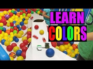 Learning colors inside the playard full of colorful plastic Balls
