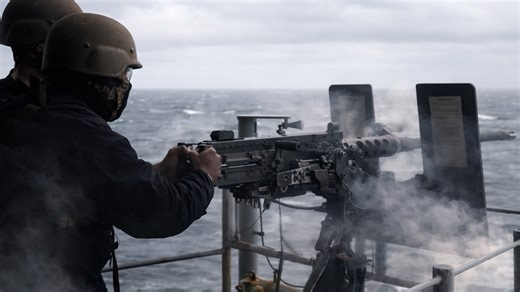 US sailors fire .50 cal machine gun on USS Nimitz