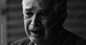 Dramatic monochrome portrait of desperate senior man crying in emotional agony, suffering alone with tearful expression. 70s person with wrinkled face struggles with sorrow and depression